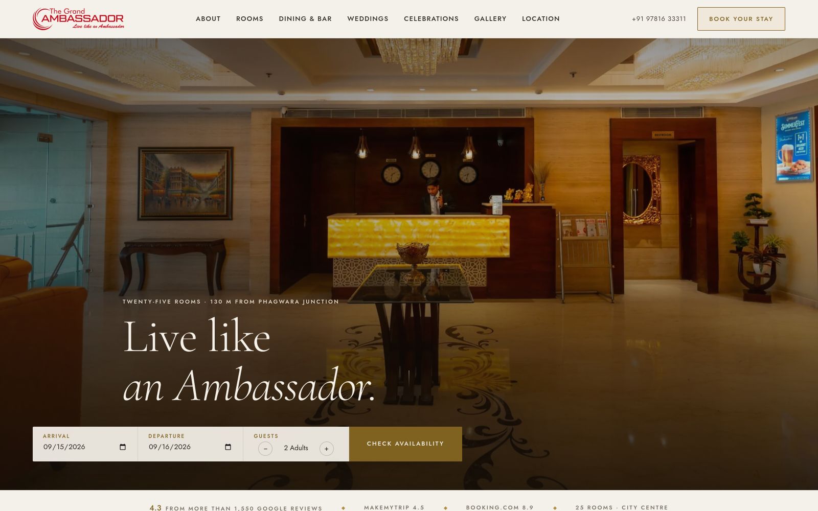 The Grand Ambassador homepage: the lit lobby behind the navigation, with the booking bar below